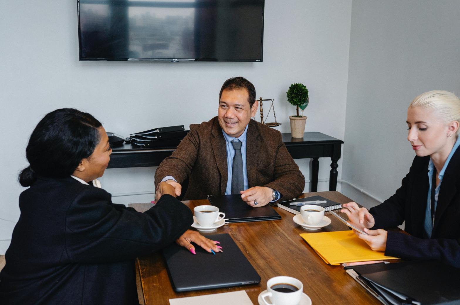 Two women and one man in an office