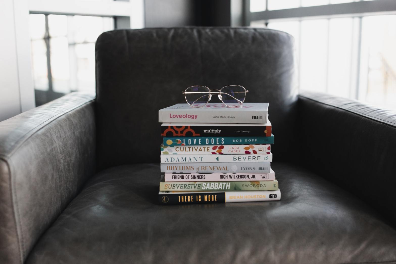 Books on a chair with an eyeglass on top
