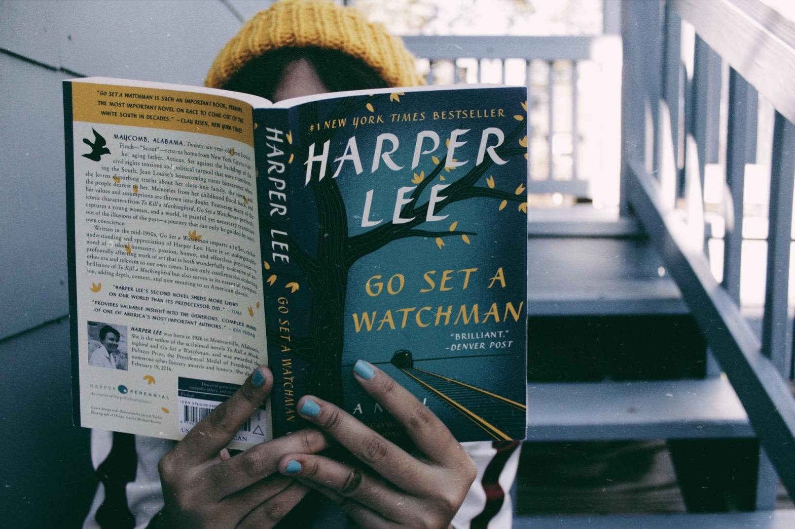 A girl reading "Go Set a Watchman" by Harper Lee