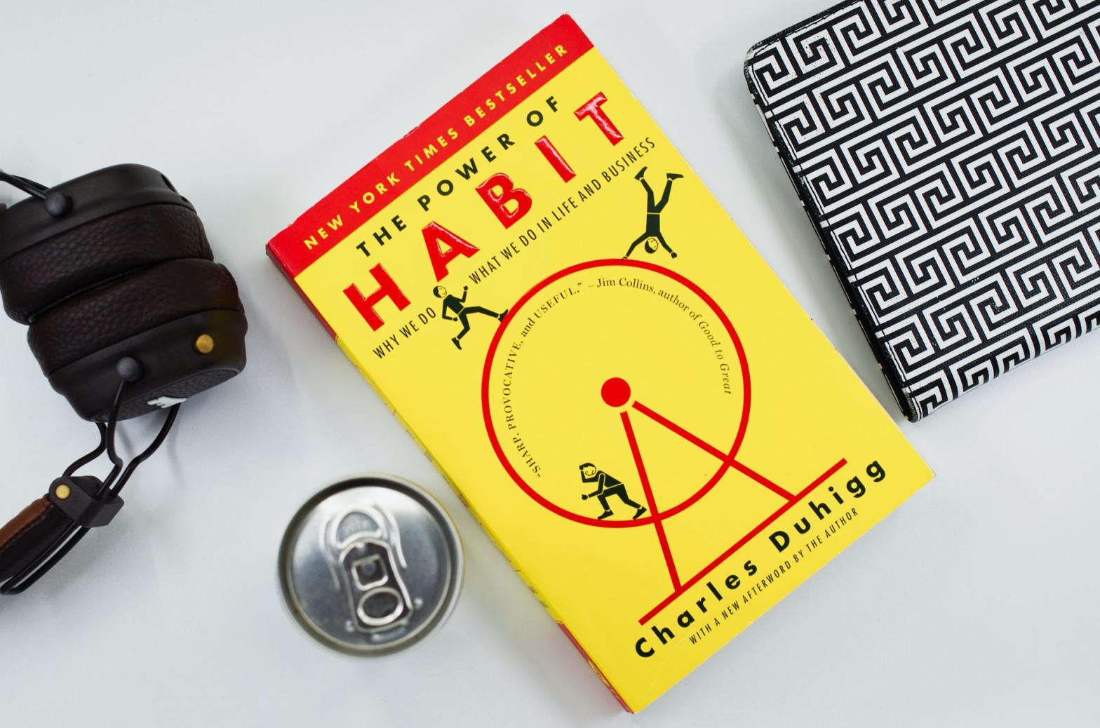 Book, headphones, notebook, and can