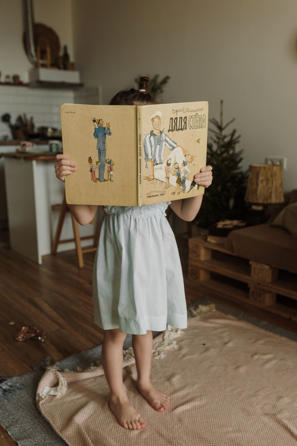 Little girl holding a book.